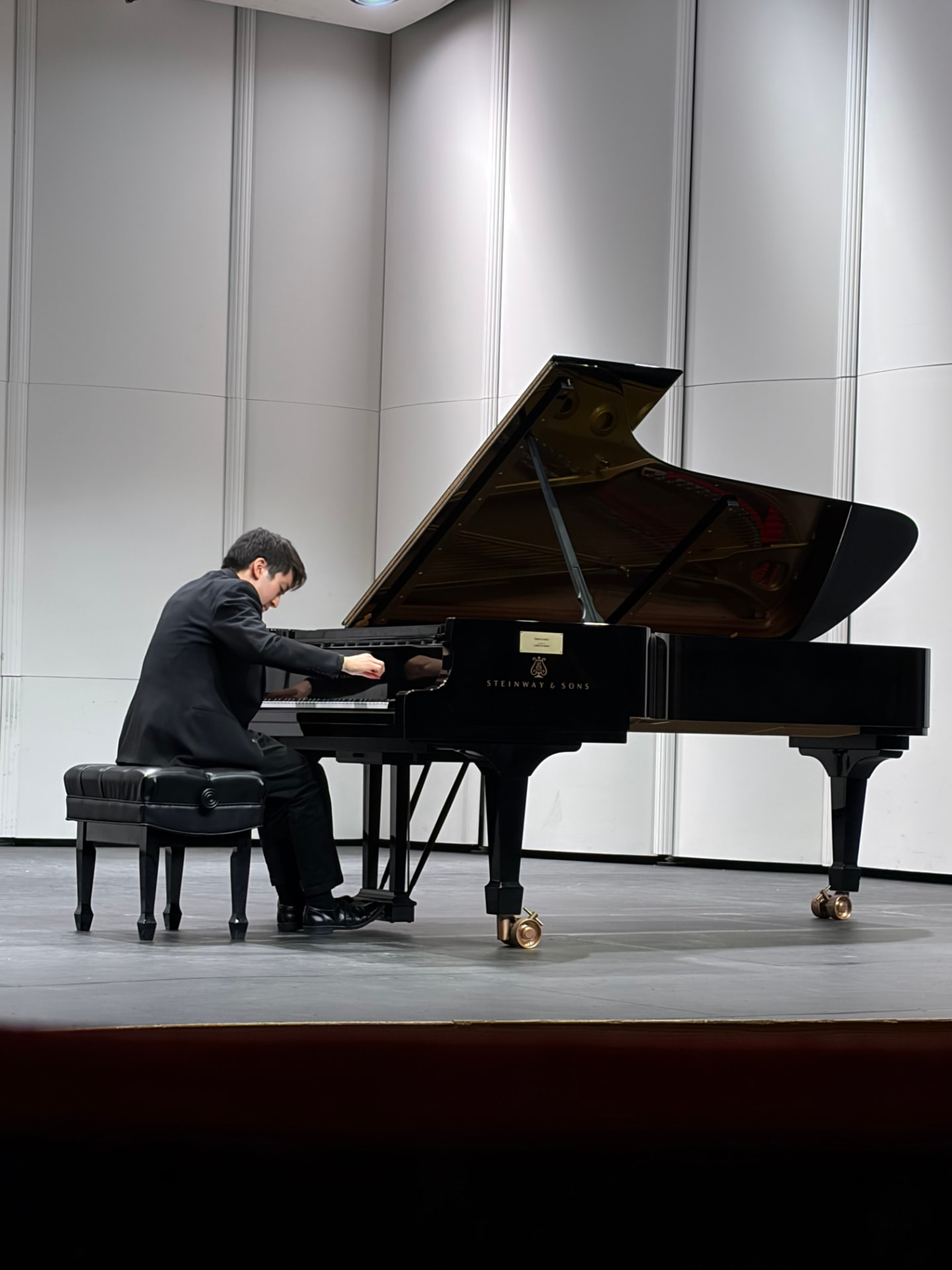 Performing at the piano on stage