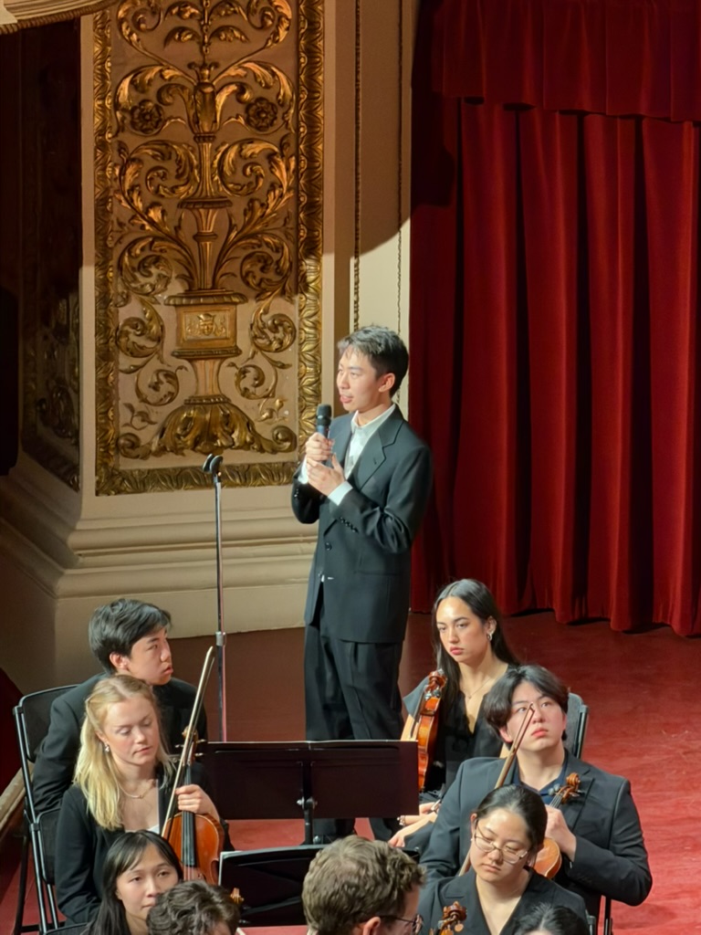 Speaking to the audience before an orchestral premiere